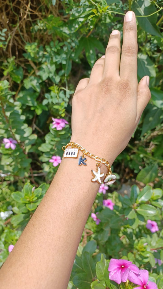 Elevate your accessory collection with our meticulously crafted charm bracelet featuring five distinct ornaments.